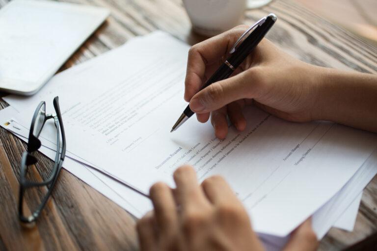 Businessman examining papers at table